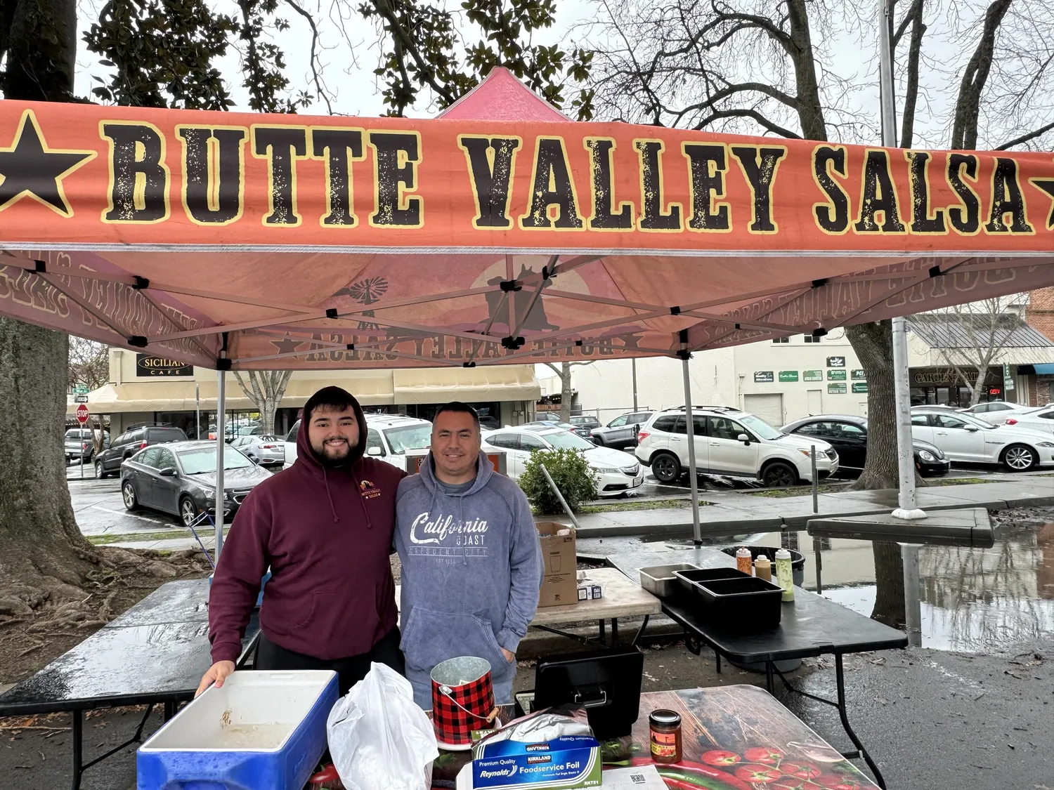 The Butte Valley Salsa canopy set up at a downtown Chico market with two of the family behind the table